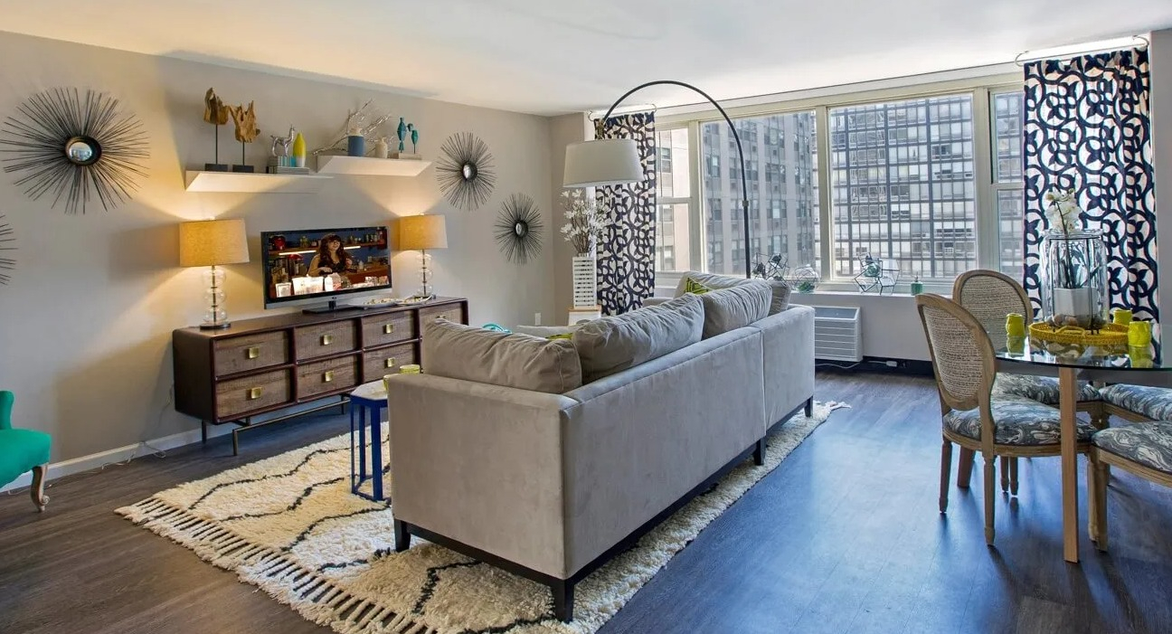 Spacious living and dining area with large windows, accent decor, and room to entertain at 860 N Dewitt Apartments in Chicago