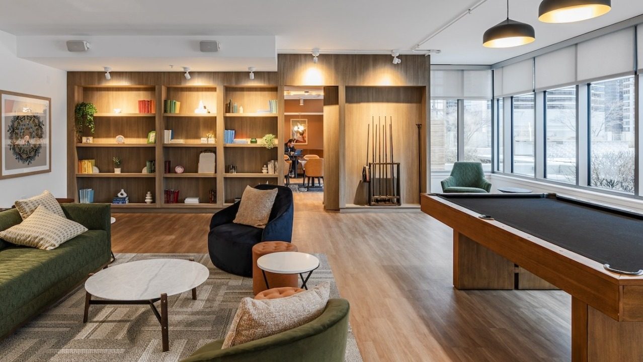 Resident lounge at Alta at K Station with billiards table, lounge seating, bookshelves, and modern lighting for entertainment and relaxation