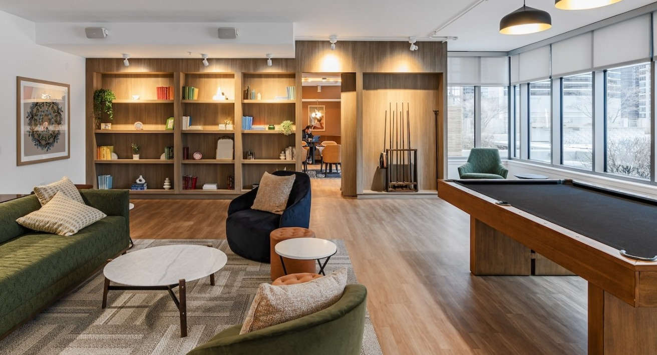 Resident lounge at Alta at K Station with billiards table, lounge seating, bookshelves, and modern lighting for entertainment and relaxation