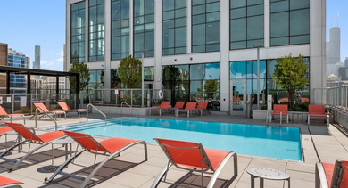 Pool at AMLI 808 in Chicago with lounge seating and calm water—an inviting amenity for summer days and after-work relaxation