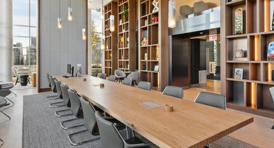 Coworking lounge with work tables, soft seating, and outlets at AMLI 808 in Chicago—perfect for remote work, study sessions, and quiet productivity