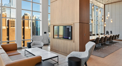 Coworking and WFH area at AMLI 808 apartments in Chicago with work tables and chairs, offering a quiet space for laptops, meetings, and study time