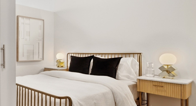 Cozy bedroom at AMLI 808 apartments in Chicago featuring soft lighting, a comfortable bed, and ample closet space for relaxed city living