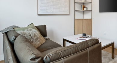 Bright living room with large windows, neutral finishes, and space for a comfy sofa at AMLI 808 apartments in Chicago—ideal for modern city living