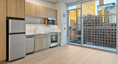 Modern kitchen at AMLI 808 in Chicago with sleek cabinetry, stainless appliances, and island seating—a stylish space for cooking and entertaining