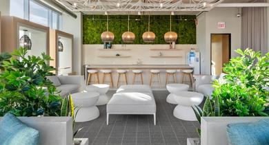 Resident lounge at AMLI 808 apartments in Chicago with communal tables and soft seating, great for remote work, hosting friends, or relaxing