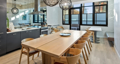 Rooftop dining lounge with full kitchen, long tables, and skyline terrace at AMLI 808 apartments in Chicago—perfect for hosting and resident events
