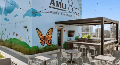 Rooftop terrace at AMLI 808 apartments in Chicago with lounge seating and skyline views, ideal for relaxing and gathering with friends