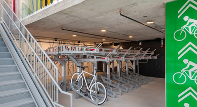 Secure indoor bike storage with wall-mounted racks and ample space at AMLI 808 apartments in Chicago, ideal for cyclists seeking reliable amenities