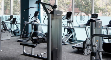 State-of-the-art fitness center equipped with various cardio and weight training machines at AMLI Lofts in Chicago