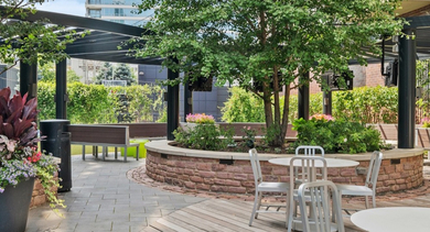 Beautifully landscaped outdoor courtyard with various seating areas and lush greenery at AMLI Lofts in Chicago