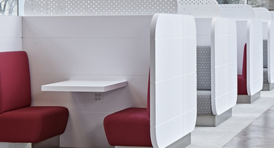 Modern private work booths with red seating and white dividers for focused work at AMLI Lofts in Chicago