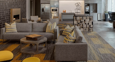 Inviting resident lounge with comfortable sofas, a large TV, and a modern fireplace at AMLI Lofts in Chicago