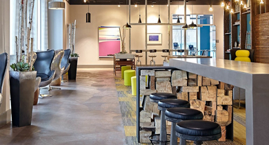 Stylish resident lounge with a long bar, various seating options, and modern decor at AMLI Lofts in Chicago