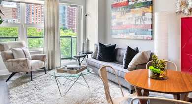 Bright and modern living and dining area with colorful decor and a large window at AMLI Lofts in Chicago