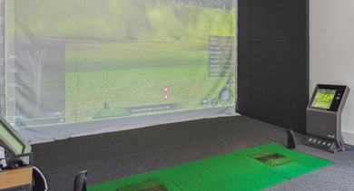 State-of-the-art indoor golf simulator at AMLI River North, offering a realistic virtual golfing experience for residents