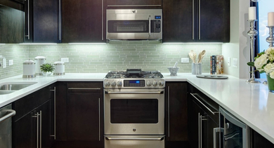 Spacious kitchen at AMLI River North, featuring a large island, stainless steel appliances, and ample counter space for cooking