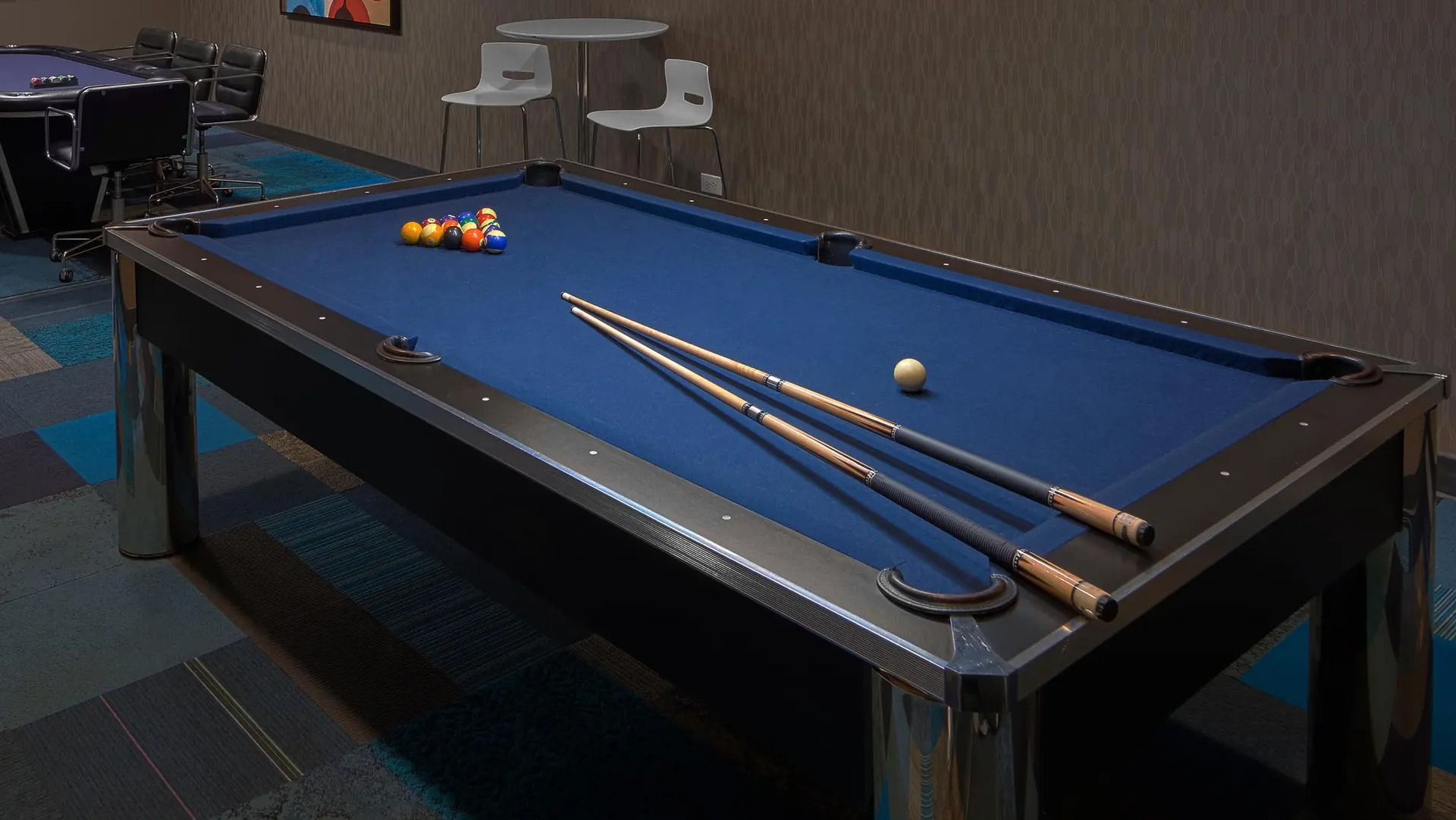 Game room with pool table, poker table, and flat-screen TV at Aqua at Lakeshore East Apartments in Chicago