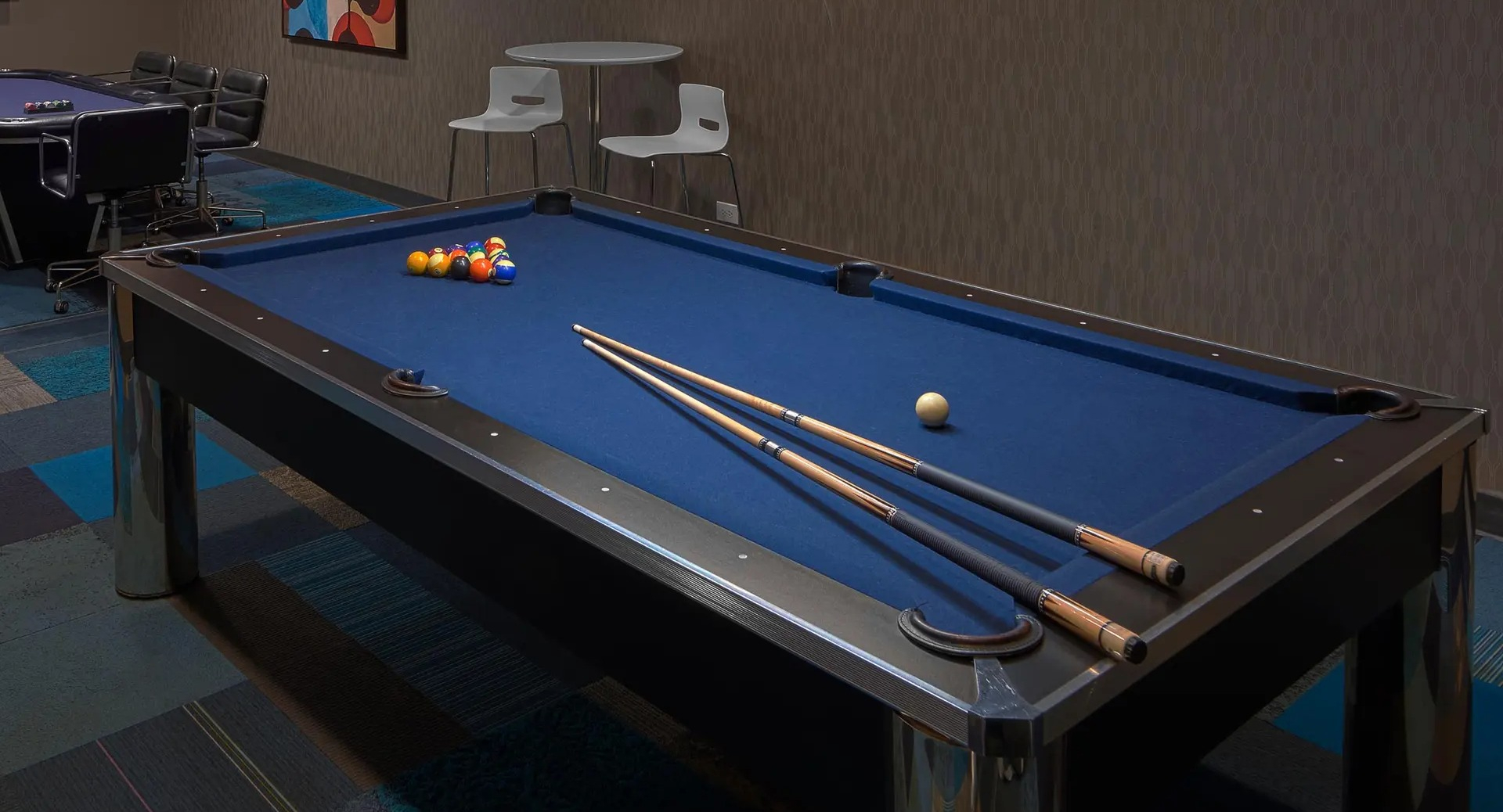 Game room with pool table, poker table, and flat-screen TV at Aqua at Lakeshore East Apartments in Chicago