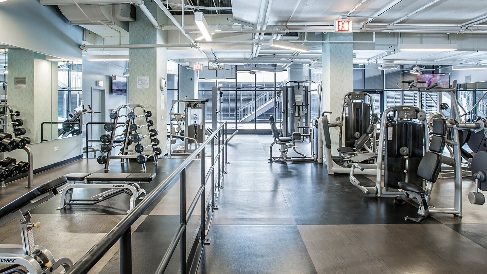 Expansive fitness center with strength and cardio equipment, free weights, and bright studio space at Aqua at Lakeshore East Apartments in Chicago