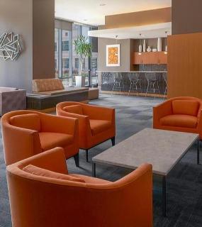 Modern lobby lounge with comfortable seating and stylish decor at Aqua at Lakeshore East apartments in Chicago