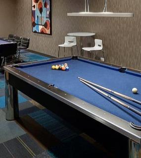 Recreation room with a pool table, poker table, and modern decor at Aqua at Lakeshore East