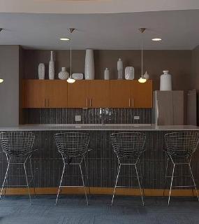 Stylish resident bar area with modern seating and sleek design at Aqua at Lakeshore East apartments in Chicago