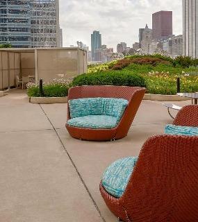 Relaxing rooftop terrace with comfortable seating and panoramic city views at Aqua at Lakeshore East apartments in Chicago