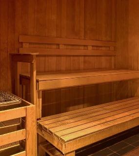 Warm and inviting wooden sauna room with tiered seating at Aqua at Lakeshore East