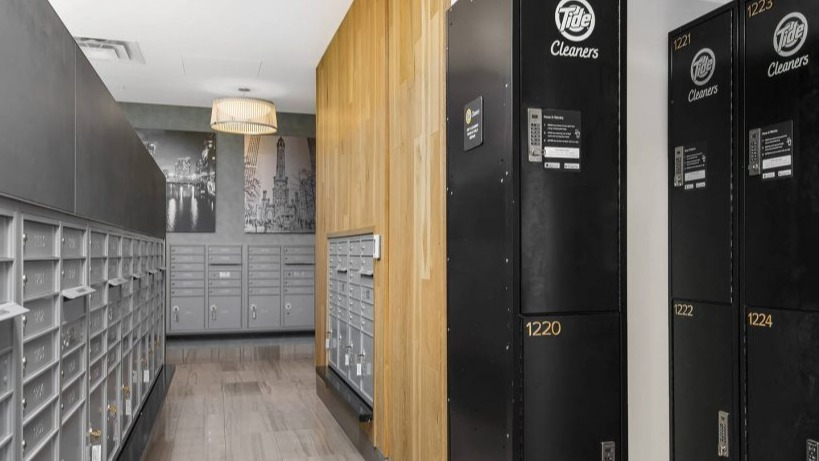 Organized mailroom at Arkadia West Loop featuring individual mailboxes and convenient Tide dry cleaning lockers