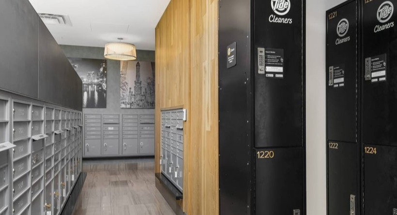 Organized mailroom at Arkadia West Loop featuring individual mailboxes and convenient Tide dry cleaning lockers
