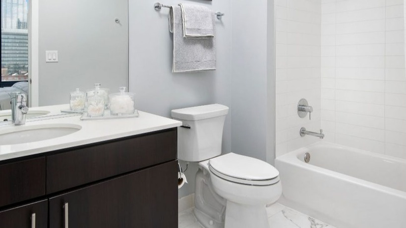 Modern bathroom at Arkadia West Loop with a sleek vanity, contemporary fixtures, and a clean tiled shower