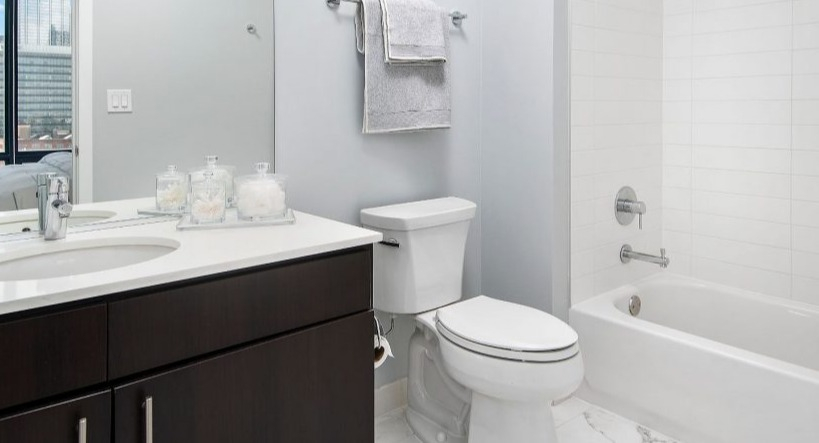 Modern bathroom at Arkadia West Loop with a sleek vanity, contemporary fixtures, and a clean tiled shower