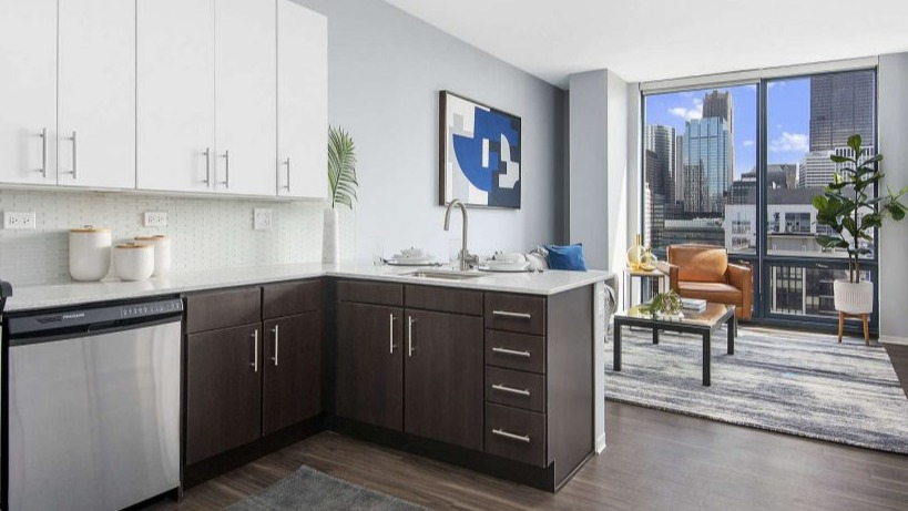 Open-concept kitchen and living area at Arkadia West Loop with modern finishes and a bright city view