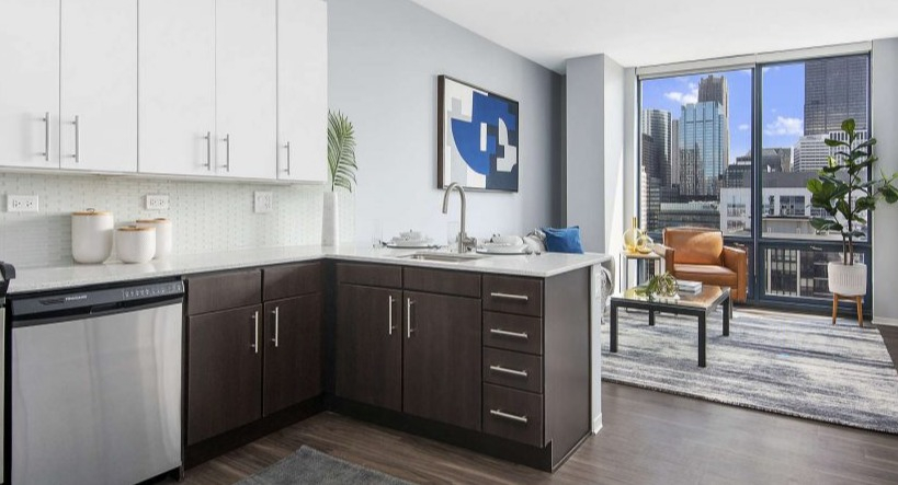 Open-concept kitchen and living area at Arkadia West Loop with modern finishes and a bright city view