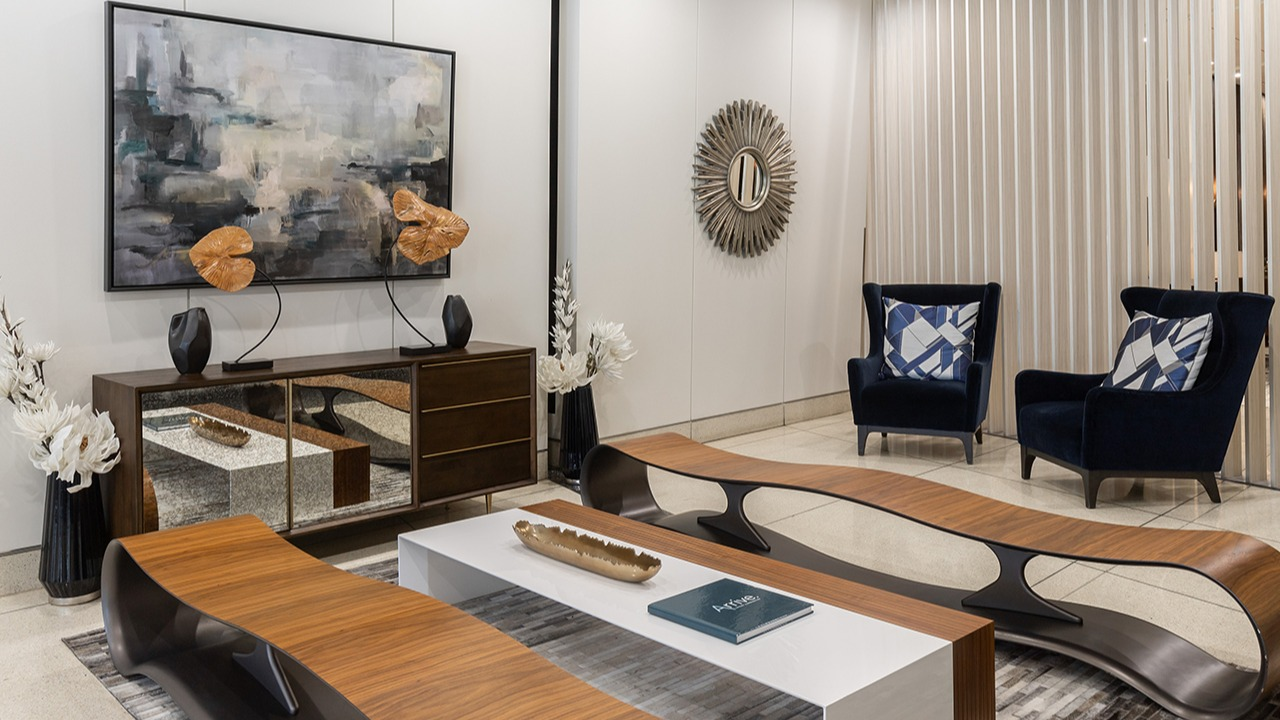 Elegant resident lounge area with modern artwork, comfortable seating, and sophisticated decor for relaxation at Arrive LEX in Chicago