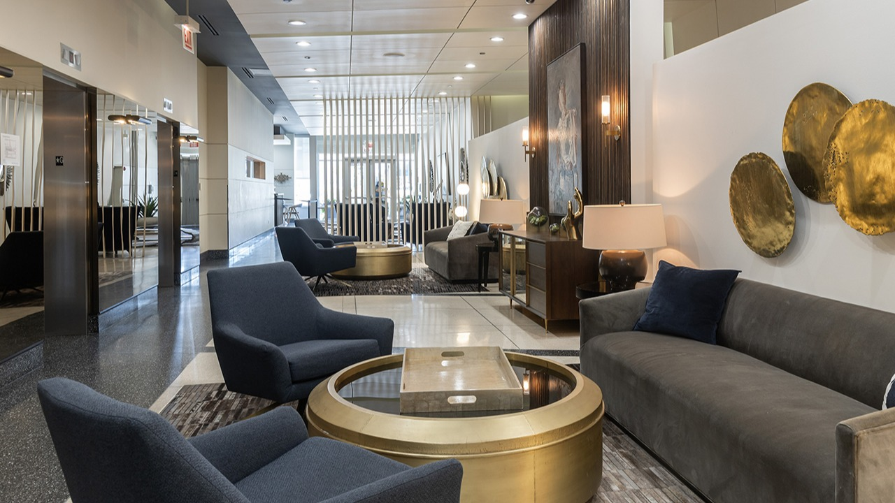 Luxurious lobby lounge featuring stylish seating, modern decor, and artistic wall accents, creating an inviting atmosphere at Arrive LEX in Chicago