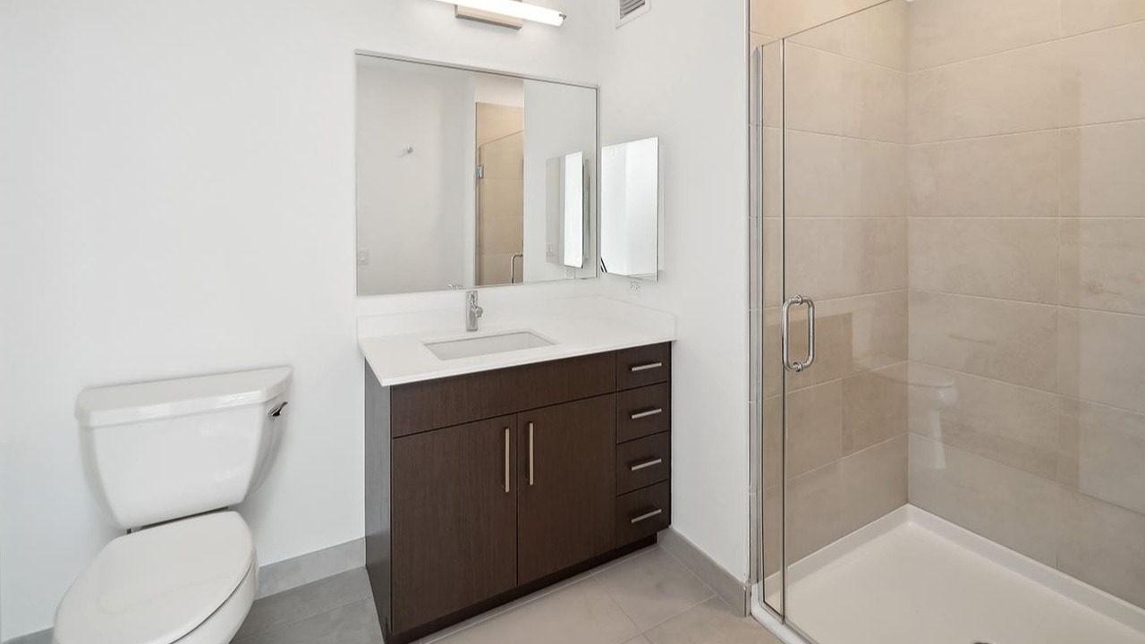 Modern bathroom with a sleek vanity, spacious shower, and clean design at Arrive Michigan Avenue apartments in Chicago