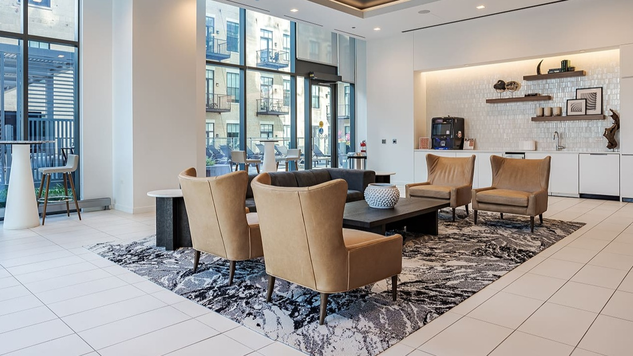 Elegant resident lounge area with comfortable seating, large windows, and a modern aesthetic at Arrive Michigan Avenue in Chicago