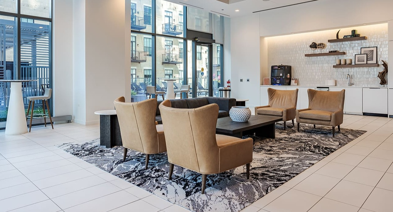 Elegant resident lounge area with comfortable seating, large windows, and a modern aesthetic at Arrive Michigan Avenue in Chicago