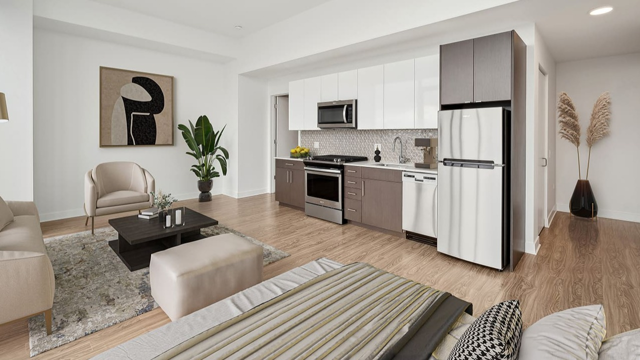 An open-concept studio apartment featuring a modern kitchen and living area at Arrive Michigan Avenue in Chicago