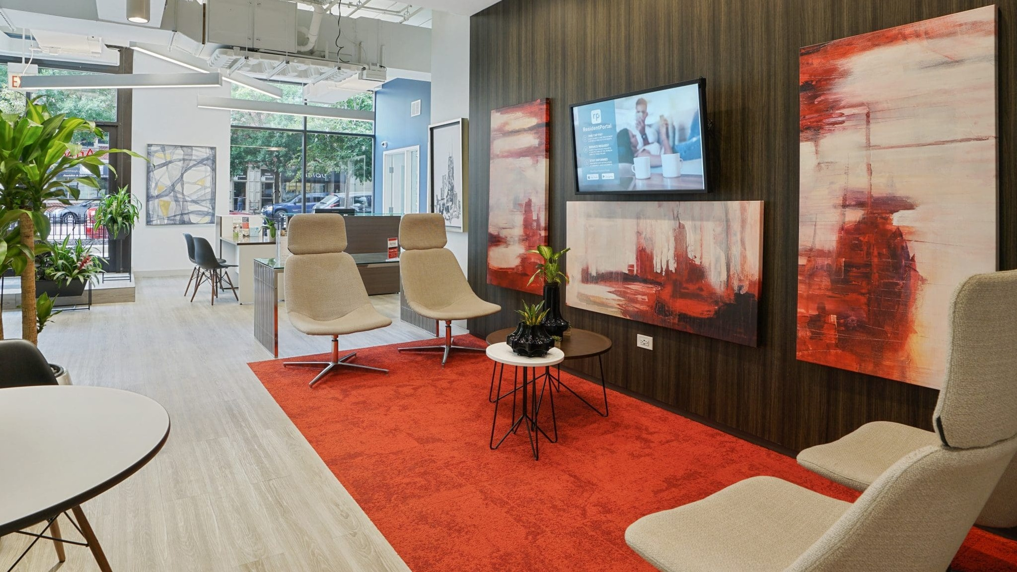 Inviting lobby lounge at Arrive South Loop apartments, featuring comfortable seating, modern art, and a welcoming atmosphere in Chicago
