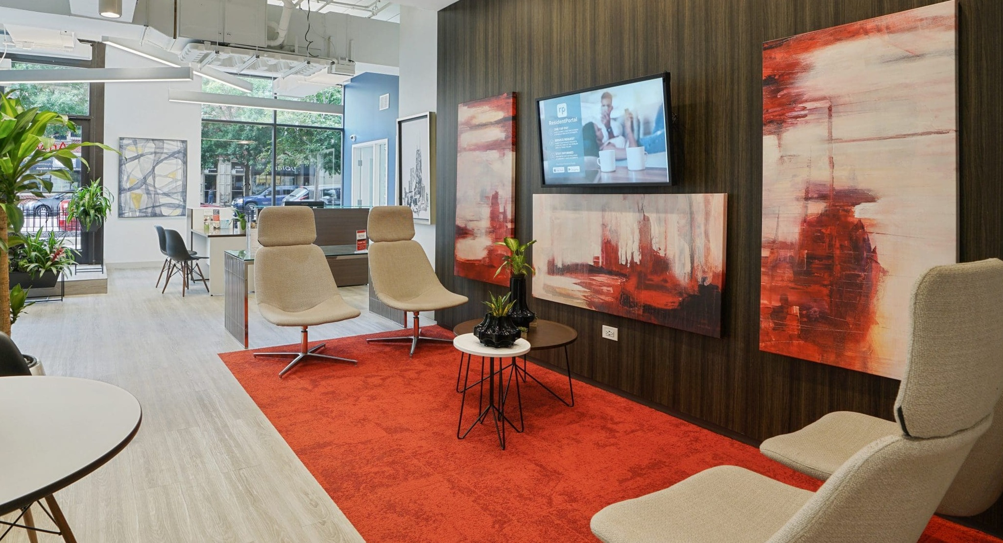 Inviting lobby lounge at Arrive South Loop apartments, featuring comfortable seating, modern art, and a welcoming atmosphere in Chicago