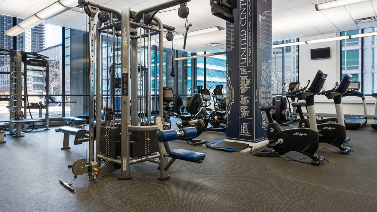 State-of-the-art fitness center at Arrive Streeterville with various weight machines and cardio equipment