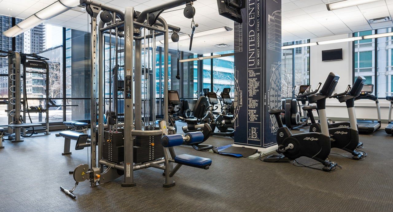 State-of-the-art fitness center at Arrive Streeterville with various weight machines and cardio equipment