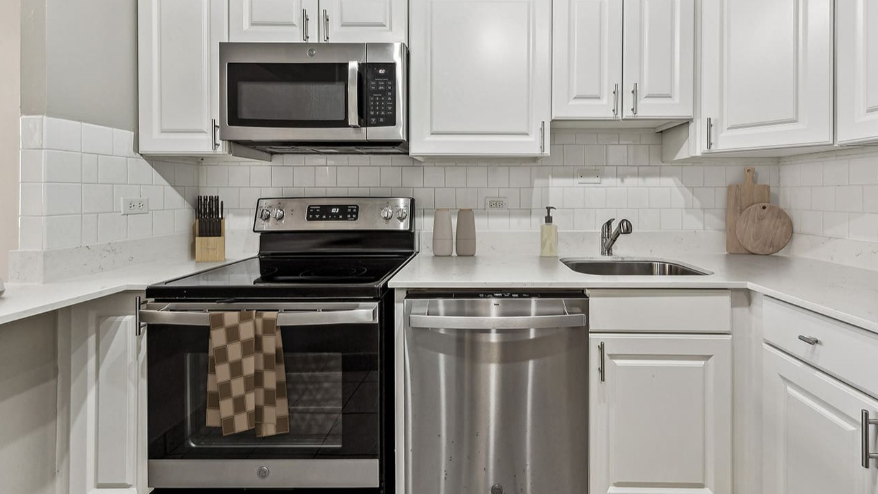 Contemporary kitchen at Arrive Streeterville featuring white subway tile backsplash and modern appliances