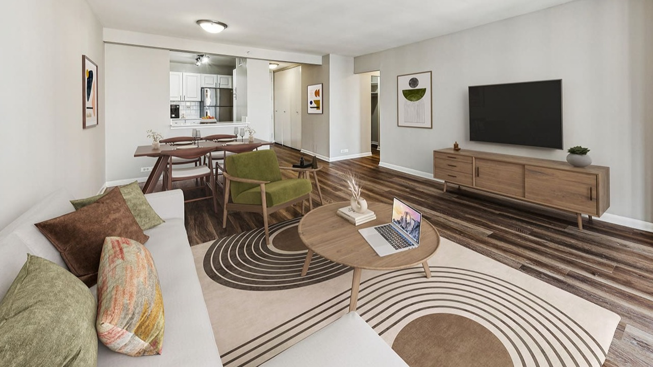 Spacious living room at Arrive Streeterville with hardwood floors, a large sofa, and a dining area