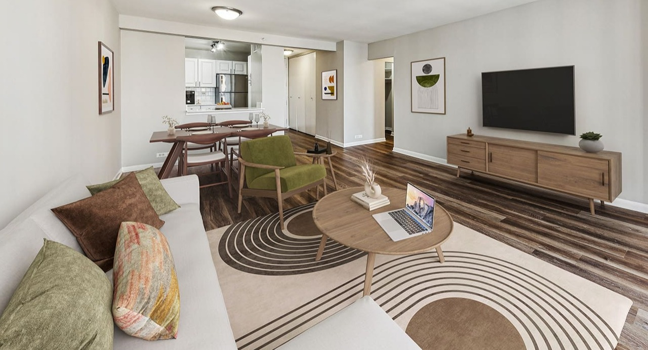 Spacious living room at Arrive Streeterville with hardwood floors, a large sofa, and a dining area