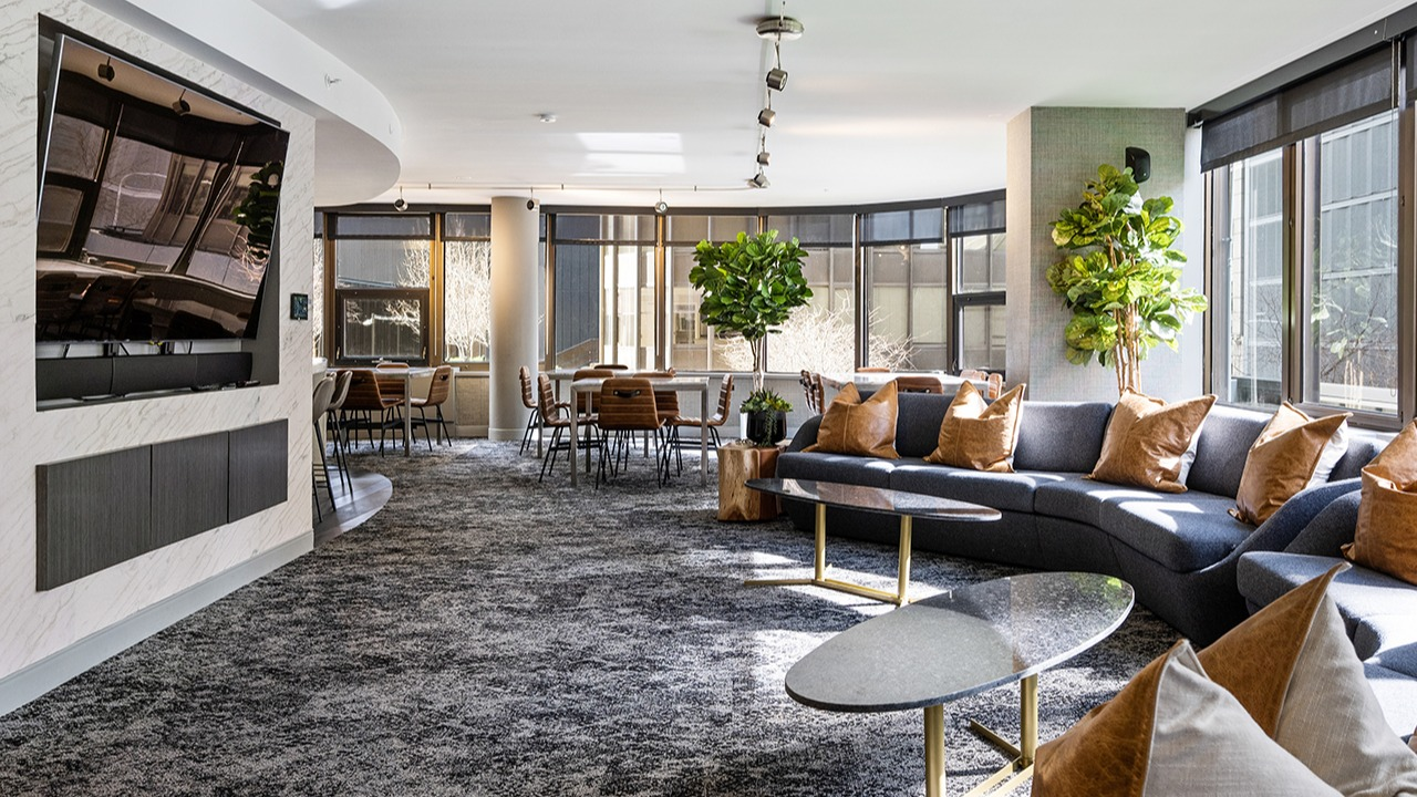 Expansive resident lounge at Arrive Streeterville with comfortable seating, modern decor, and large windows