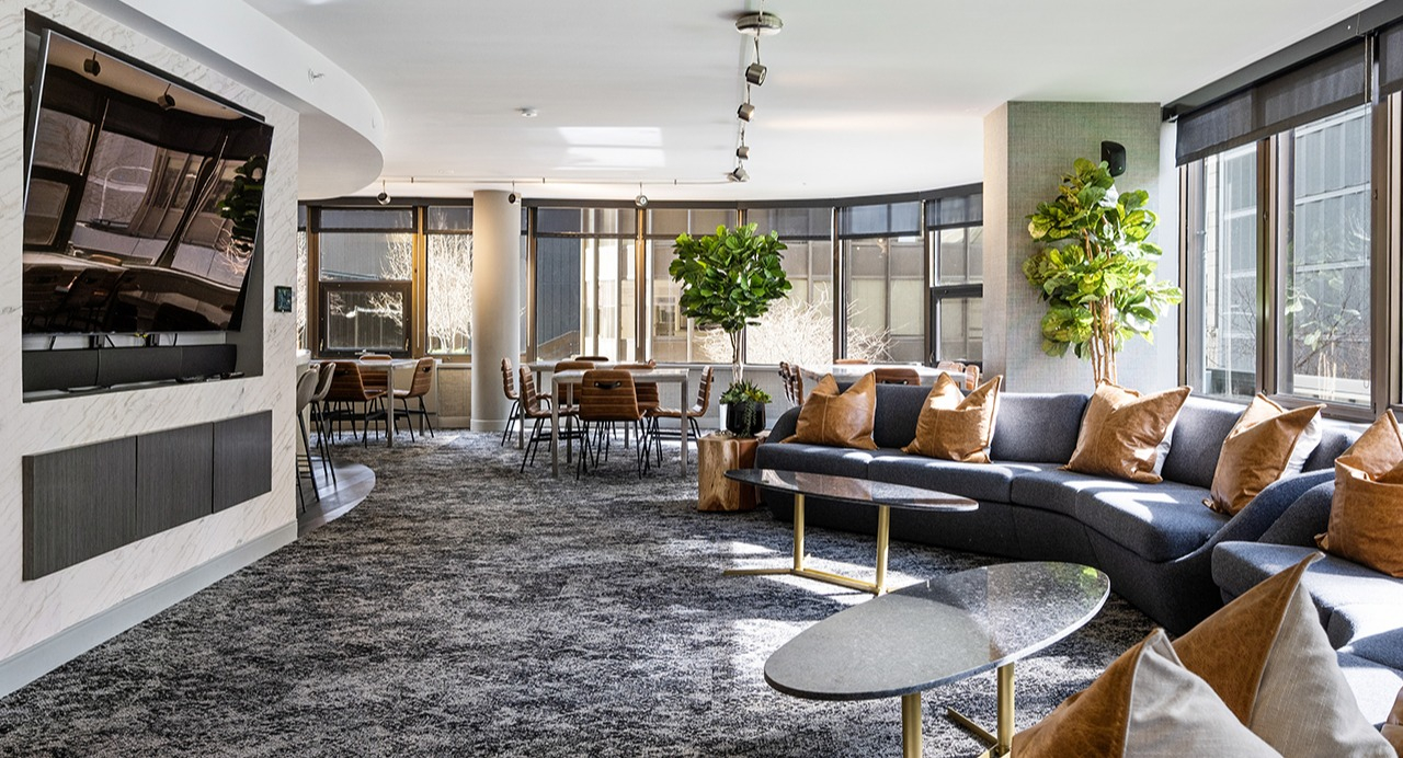 Expansive resident lounge at Arrive Streeterville with comfortable seating, modern decor, and large windows